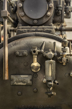 Details of an old steam engine machine on a court in Csernat, Transylvania, Romania