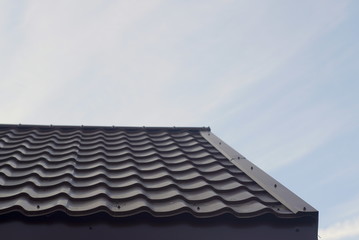 Fototapeta na wymiar Modern Roof Covered With Tile Effect Pvc Coated Brown Metal Roof Sheets.