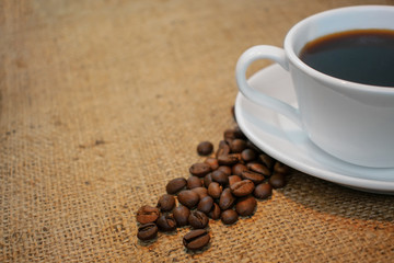 Cup of coffee on burlap background