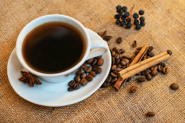 Cup of black coffee on burlap background