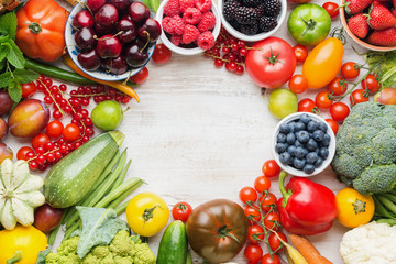 Healthy summer fruits vegetables berries arranged in a circle frame, cherries peaches strawberries...