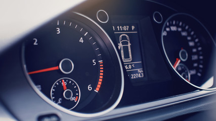 Modern car dashboard. Tachometer, fuel level and icons on the panel screen.