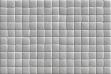 Wall covered in small white tiles texture