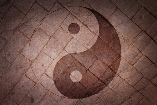 Chinese yin yang sign on a background of a brick surface