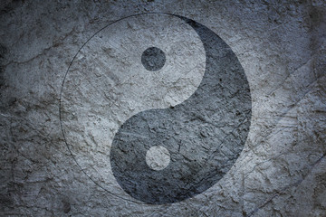 Chinese yin yang sign on a background of a concrete surface - 223422615
