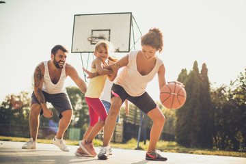 Family playing basketball together.