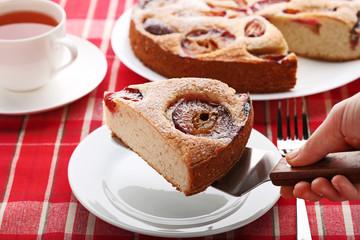 Homemade sweet plum cake with cup of tea