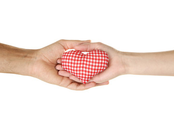 Obraz premium Female and male hand holding red fabric heart on white background