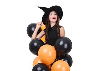 Young woman in halloween costume with balloons isolated on white background