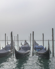 Fototapeta na wymiar Gondolas Parked at Shore, Venice, Italy