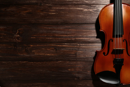 Violin on brown wooden table