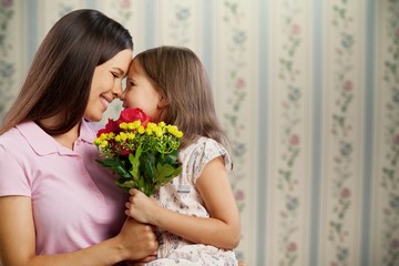 Happy Mother and daughter hugging  with flowers