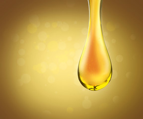 Gold oil drops on yellow background