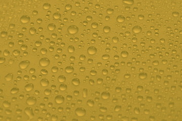 natural water drops on yellow golden background texture