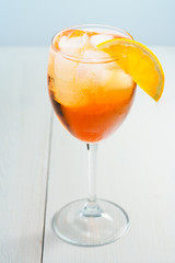 Aperol Spritz served with an orange slice in wine glass. White background, high resolution