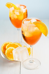 Aperol Spritz served with an orange slice in wine glasses. White background, high resolution