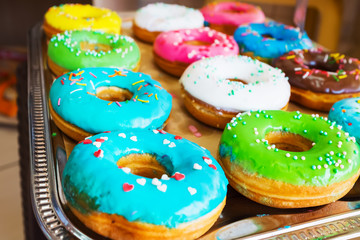 various baked donuts, sweet food. On the tray