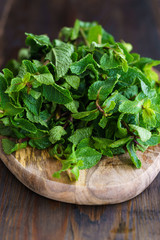 Fresh mint on a wooden board. Dark background, high resolution