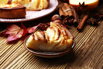 Apple tart. Gourmet traditional holiday apple pie sweet baked dessert food with cinnamon and apples on vintage background. Autumn decor. Rustic style.