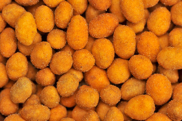 Peanuts in a crispy crust occupy the entire space frame. Background image. View from above. Close-up. Macro photography.