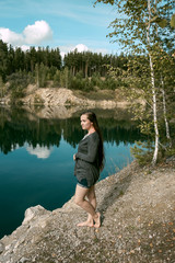 Fototapeta na wymiar A young woman on the lake in nature