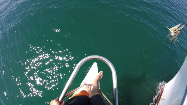 Walking on edge of bow of boat, POV