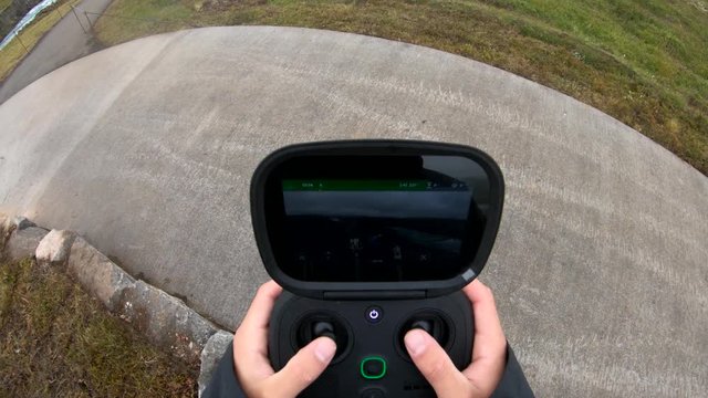 POV, person controls drone with remote