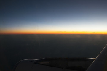 Looking at the sunrise from an airplane window
