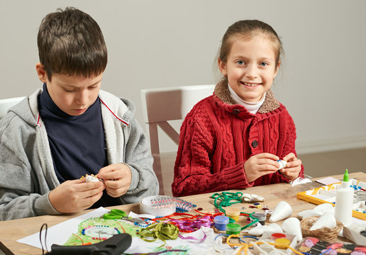 Childrens making decorations for new year holiday. Painting watercolors. Top view. Artwork workplace with creative accessories.