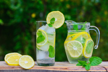 Lemonade from lemon and mint on a wooden table