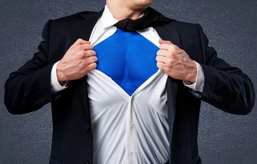 Businessman tears shirt on himself to show