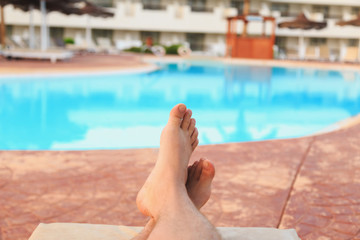 man relaxing by the pool