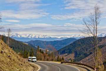 Fototapeta premium Two vans on a winding mountain road