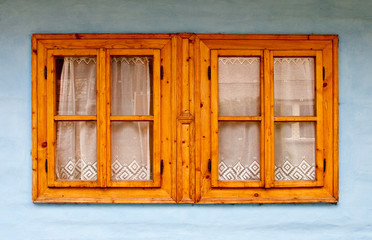 Wooden window on blue wall