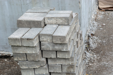 Stone bricks piled near a wall at a construction site