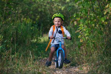 A little boy on a balance bike
