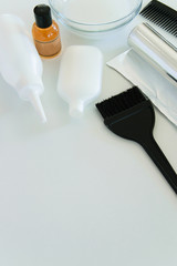 Hair dye tools on white background, space for text