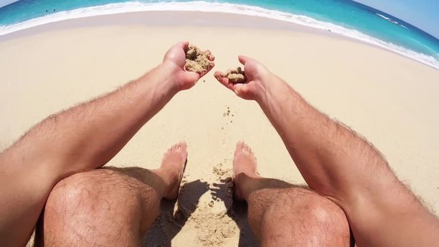POV, person feels sand on tropical beach