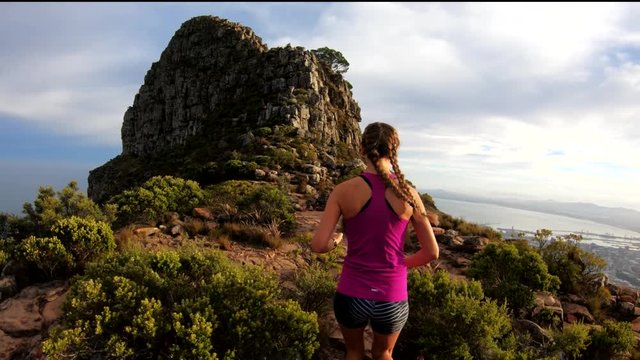 Hiker on rocky cliff in Cape Town, POV