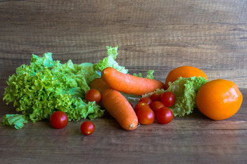 Vegetables, Harvest of autumn. Carrots, tomatoes, lettuce leaves.