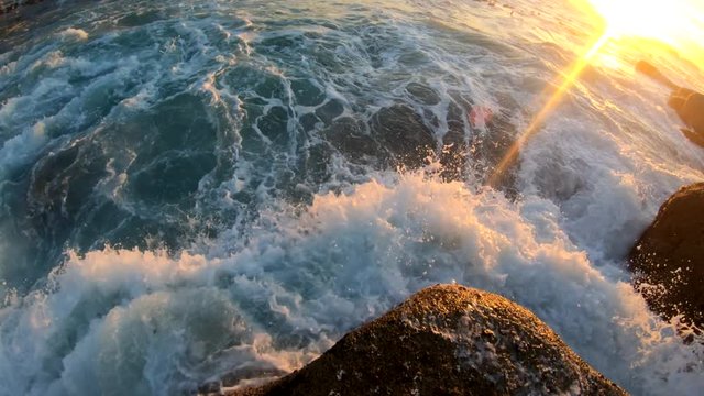 Waves crash on Cape Town beach during sunset, POV