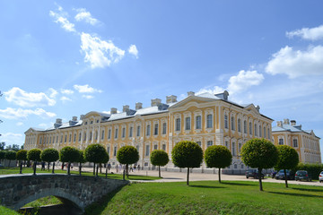 Great beautiful palace with trees and grass under the sky