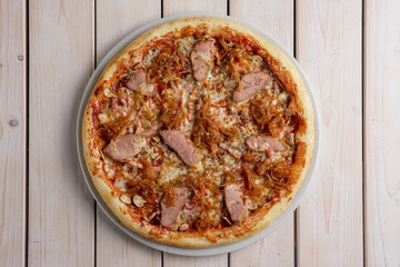 Freshly baked pizza with beef and fried onion
