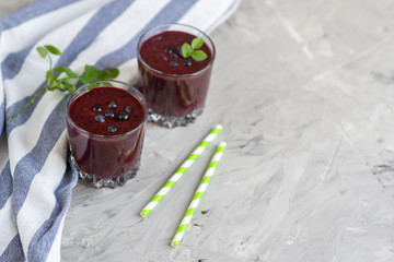 Delicious wild blueberry smoothie milk yogurt ice cream gray background summer drink concept