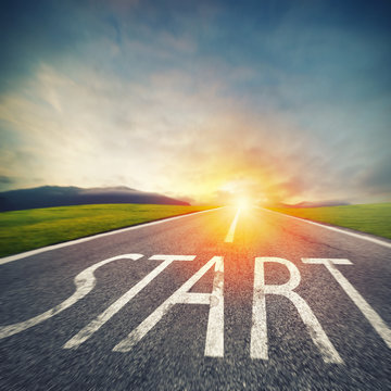 Start written to the ground on a road at sunset. Concept of new beginning and starting new opportunities