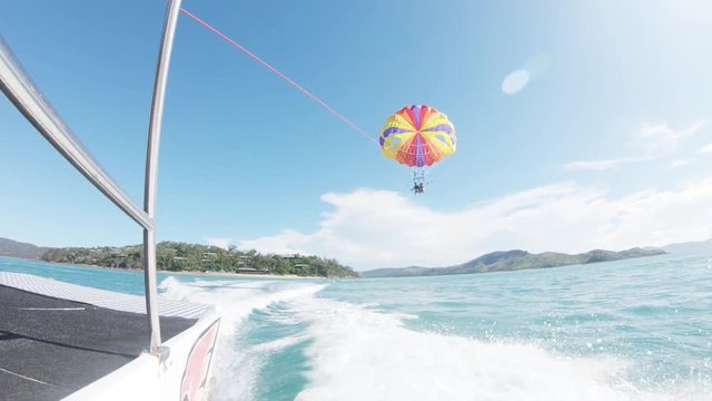 People parasail behind boat in Australia, POV