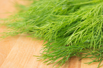 fresh green dill on wooden background.