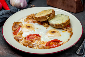 Fried eggs with tomatoes and toast