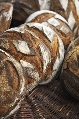 Rustic bread on wicker baskets in a bakery