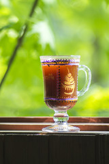 glass of Irish coffee on beautiful green natural background.